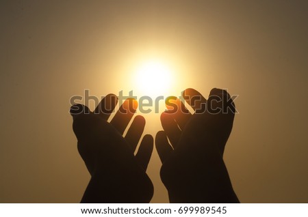 The woman reaches out hands toward the sun. Future is in your hands concept. Freedom.