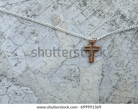 Christian Cross necklace on vintage grunge background with copy space