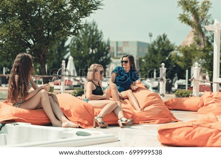 Summer mood joyful young women on amazing holiday resort, sunglasses, having fun in casual outfit in the tropical garden near hotel pool resort. Nature colors, expressing positivity, joy, happiness