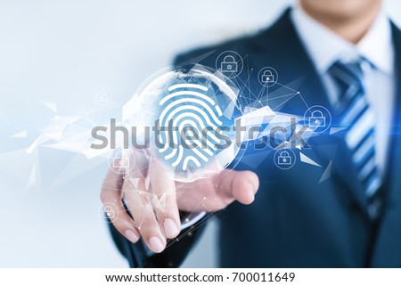 A businessman is touching a word with an abstract future background. Compute science, technology, business, internet concept. Fingerprint. Royalty-Free Stock Photo #700011649