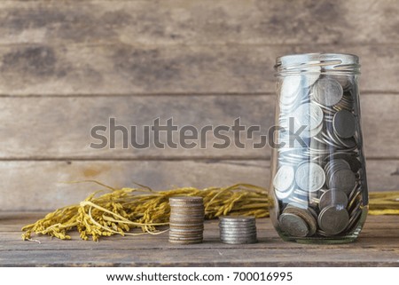 Concept of saving money. Silver coins on a wooden table.