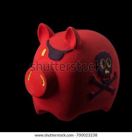 Red pig money box with a picture skull and bones on its side figurine on a black background