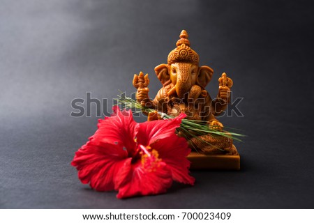 Happy Ganesh Chaturthi Greeting Card showing photograph of lord ganesha idol with pooja or puja thali, bundi laddu/modak, durva and hibiscus or jasvand flower
 Royalty-Free Stock Photo #700023409