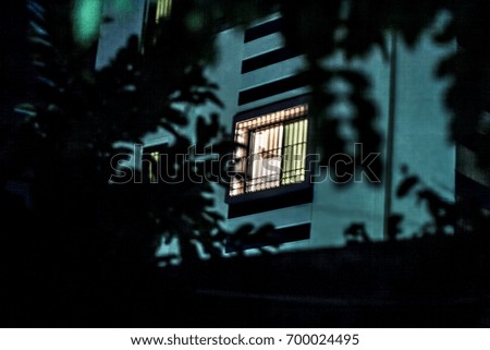 Rear window of a building at night.