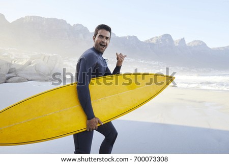 Shaka sign surf dude holding board, portrait