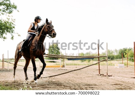 Picture of young pretty girl riding horse