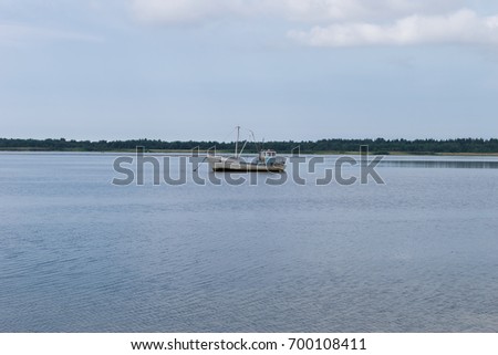 Lonely boat in still sea.