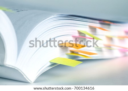 Close up White book marked by sticky note Royalty-Free Stock Photo #700134616