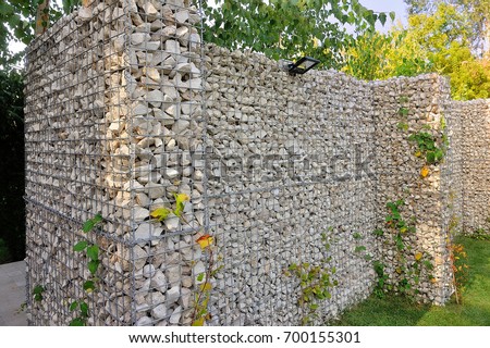 Gabion fence made of natural stone and metal mesh