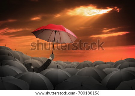 Businessman holding red umbrella hand up to be leadership concept to different choice business to success goal.  