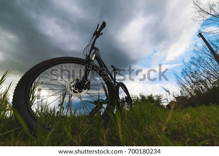 Mountain biking on green meadow and blue sky background