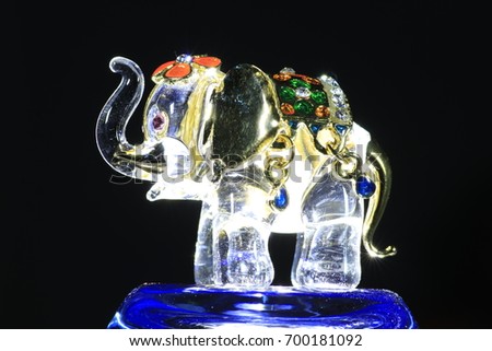 the elephant made by glass on blue glass and black background