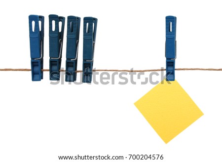 Yellow paper note hanging on on the rope with clothespins 