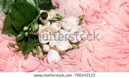 White mauve pink and green floral wedding background - fragile fresh freesia flowers on decorative rose pattern structure material