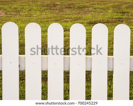 White fence backdrop is a lawn.
