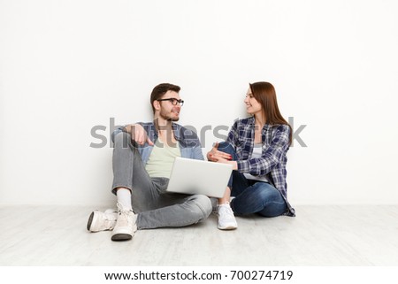 Couple conversation with laptop. Man and woman watching movie on laptop computer abd discuss it, white background, studio shot