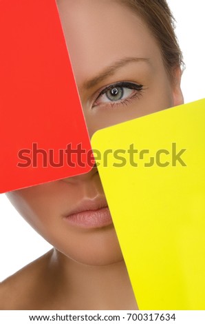 European young woman with red and yellow card isolated on white