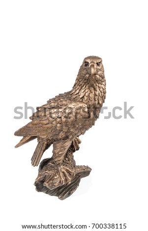 Bronze statuette sitting on a branch of an eagle and looking at camera isolated on white background