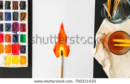 Artstic brush sleep white sheet of paper with a picture of fire art