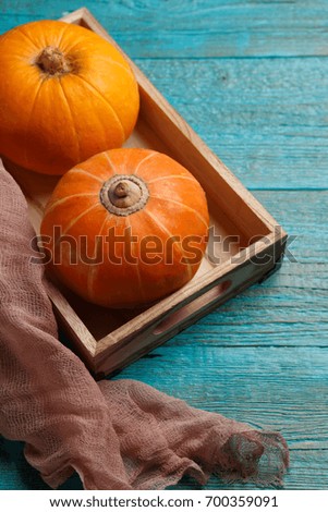 Wooden table with pumpkin, fabric