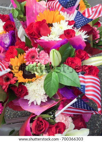 Stars and strips (American flag) with colorful flowers to celebrate the 4th of July in the US.
