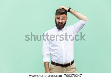 Not sure. Young adult businessman have a doubt. Studio shot Royalty-Free Stock Photo #700370347