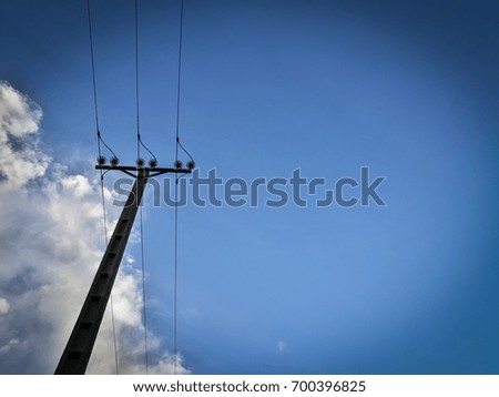 Electric pole looking at blue sky