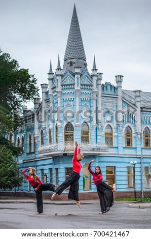 the group of children dancers - acrobats . early morning on the background of a historic building