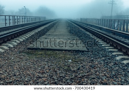 Walking in the fog.   rail road tracks , the prospect forward .