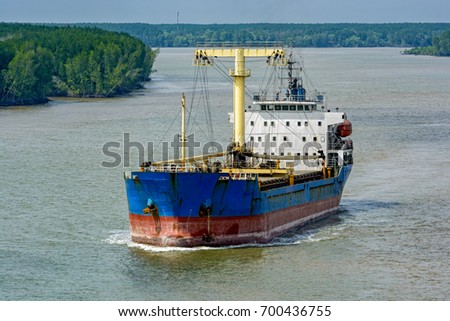 Bulk Carrier vessel sails down the Song Long River from Ho Chi Minh City. It is in ballast, having discharged its cargo in the port. Vietnam, Southeast Asia.