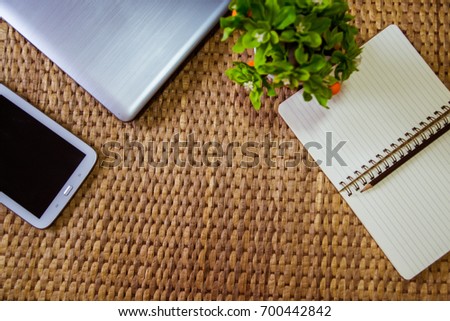 Office desk with laptop, tablet , notebook,Little  tree and pencil. Top view with copy space
