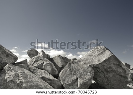 A rock wall against a blue sky. Royalty-Free Stock Photo #70045723