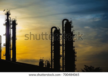 Gas distillation tower in silhouette image on sky sunrise background