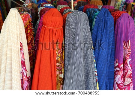 The various of colorful fabric rolls sale at the clothes market.