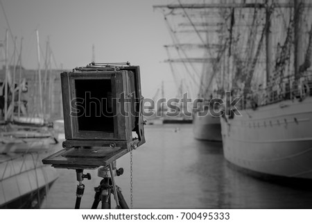 An old retro vintage film camera on a tripod. Large format camera, Black and white.