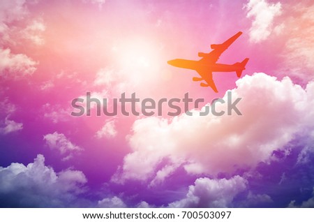 Airplane frying in the blue sky and clouds. Silhouette image.