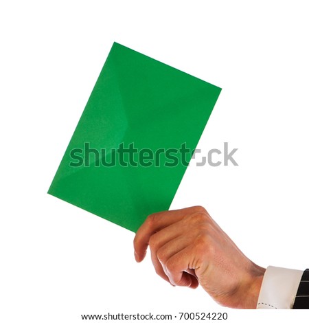 Businessman holds a green envelope isolated on a white background