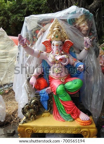 Indian Hindu God Lord Ganesha Statue made of clay and coated with ceramic colors, handmade artistic effects, Beautiful artifacts