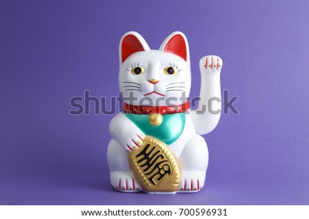 a Maneki-neko plastic cat, Symbolizing luck and wealth, on a pop and colorful background.
Minimal color still life photography Royalty-Free Stock Photo #700596931