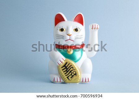a Maneki-neko plastic cat, Symbolizing luck and wealth, on a pop and colorful background.
Minimal color still life photography Royalty-Free Stock Photo #700596934