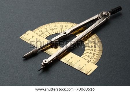Pair of compasses and protractor isolated on white