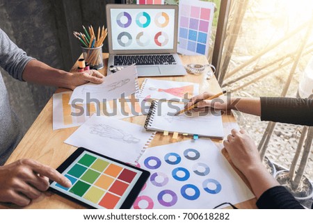 Two young dressmaker or designer colleagues working and discussing fashion project designers and drawing sketches for clothes, profession and job occupation, Fashion Designer Stylish Concept.