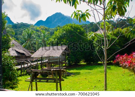 Traditional wooden houses in the Kuching to Sarawak Culture village. Landscape with a mountain on the horizon. Borneo, Malaysia