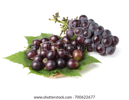 Fresh bunch of grapes with leaves isolated on white background 