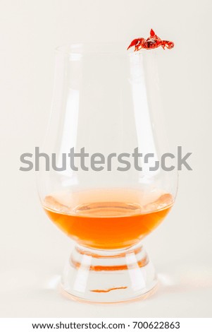 single malt tasting glass with scorpion, single malt whisky in a glass, black  background, party