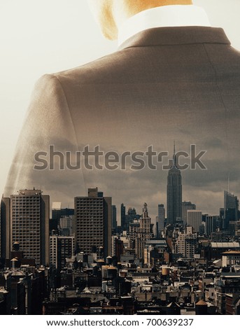 Back view of thoughtful businessman silhouette on city background. Tomorrow concept. Double exposure 