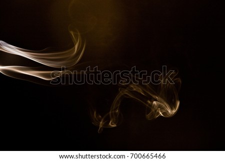 Brown smoke on black background.