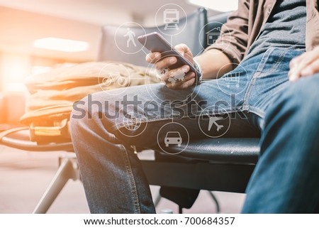 Young travelers Use smartphone to find travel information from the application. waiting for mass transit system go vacation on weekend over blurred Terminal. select focus and Film Tone with Light fair