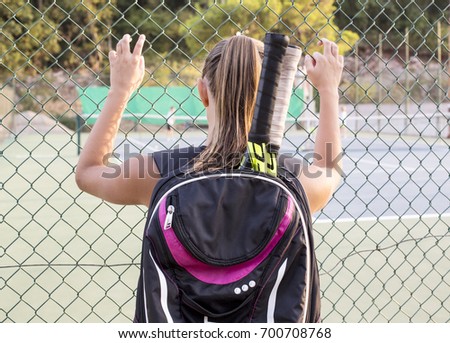 Young girl watching tennis game