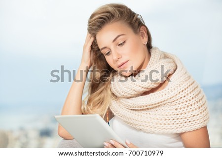Portrait of a beautiful smart female working at home on the tablet, wireless communication, student girl doing homework on the touch pad, modern life of young people